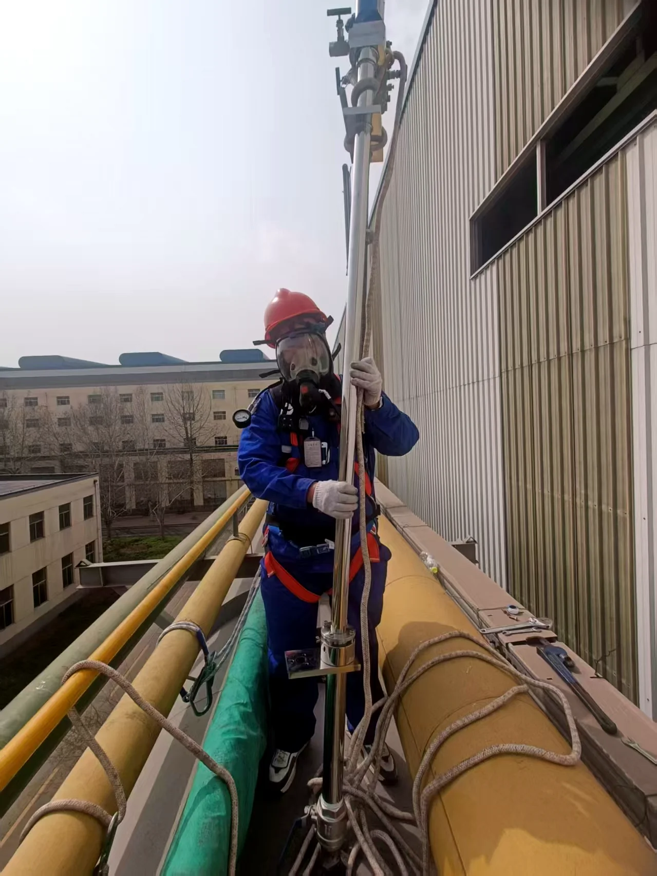 Technician working at height on a large-pipeline averaging Pitot installation