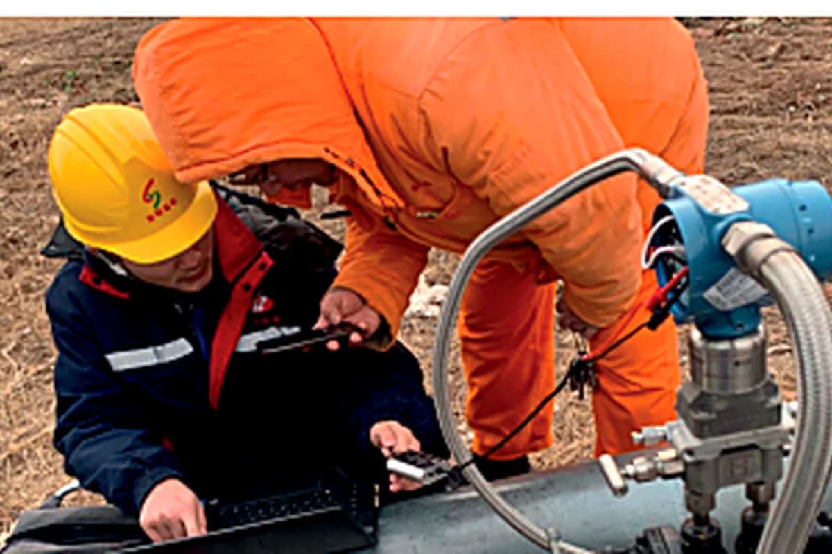 Technicians reviewing balanced flow meter data in the field