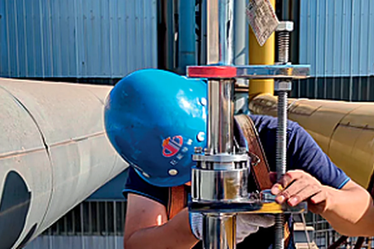 Technician fastening an insertion flow meter assembly